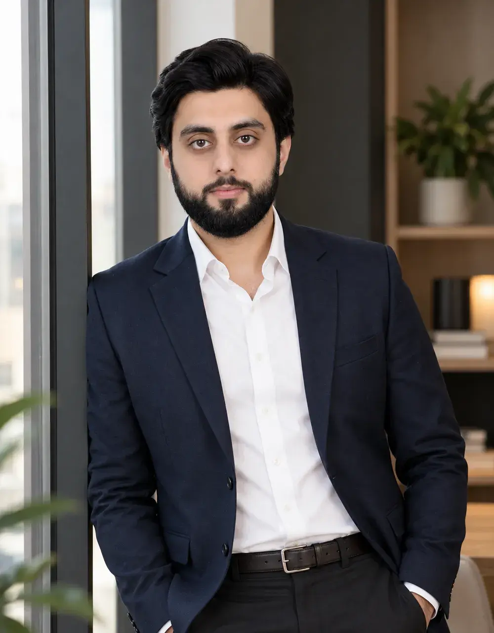 The Launch VRO founder standing by a window in a navy blazer and white shirt.